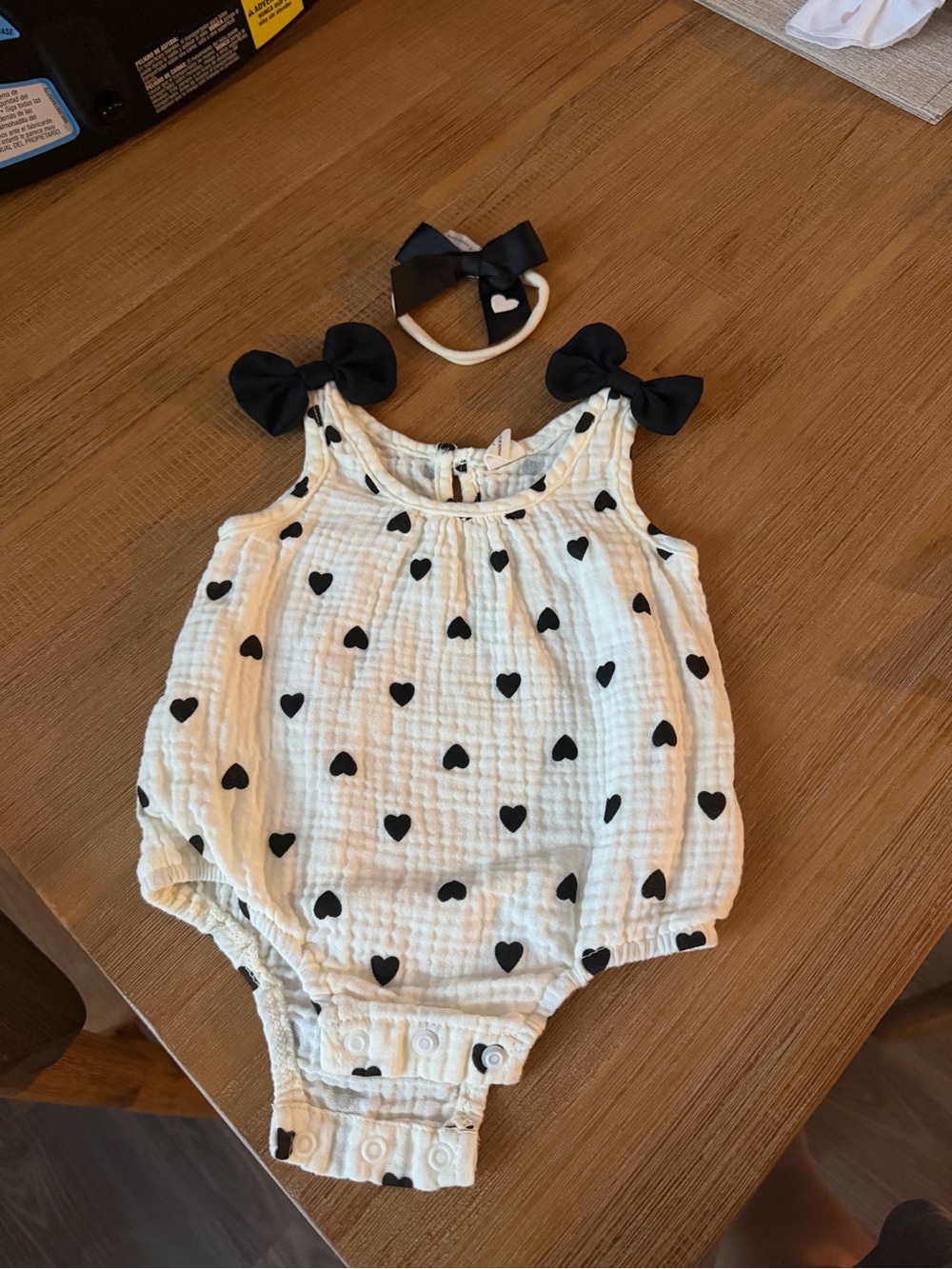 SHEIN Cream Romper with Black Heart Print and Bow Accents